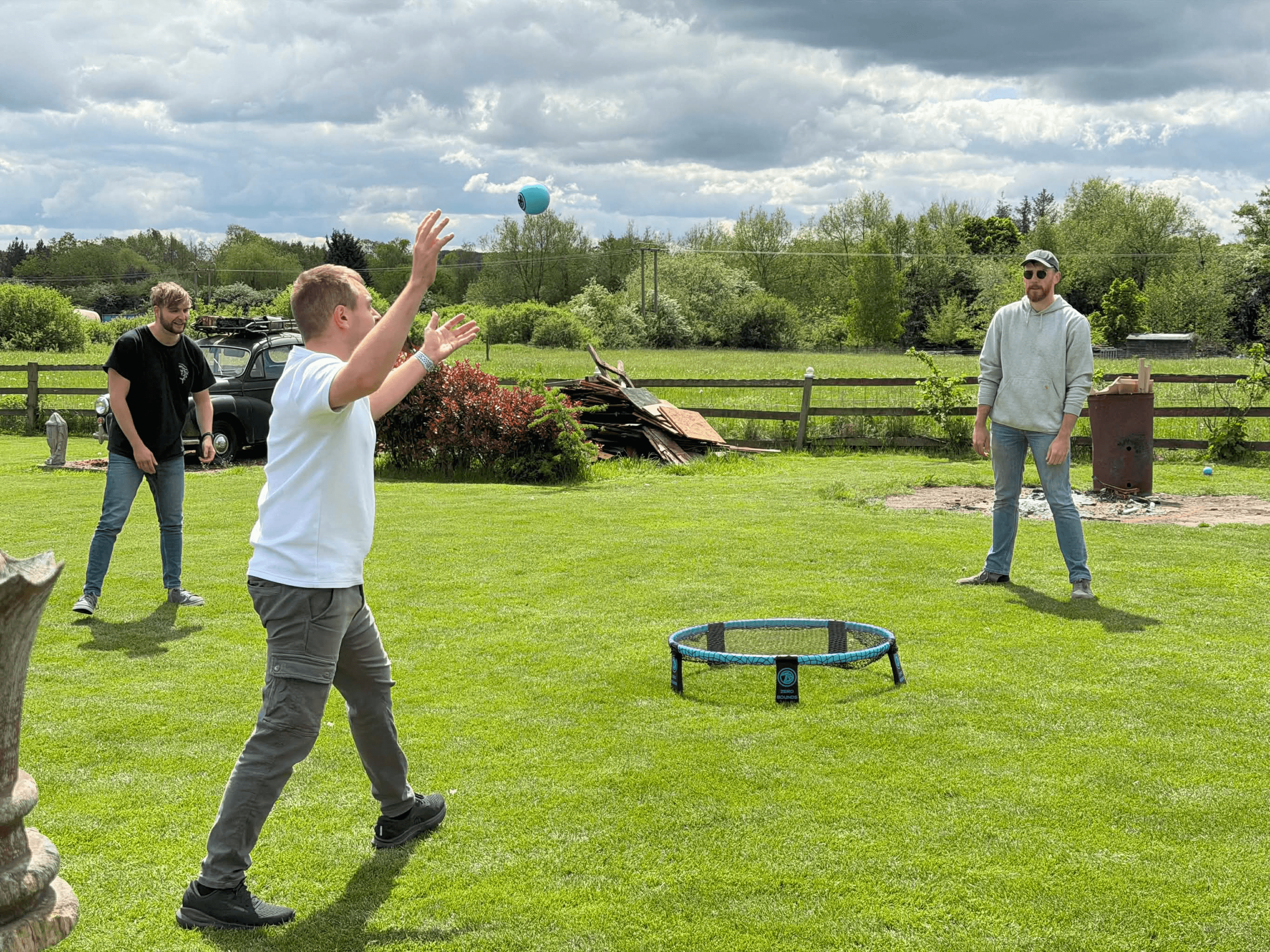 Roundnet being played in a garden