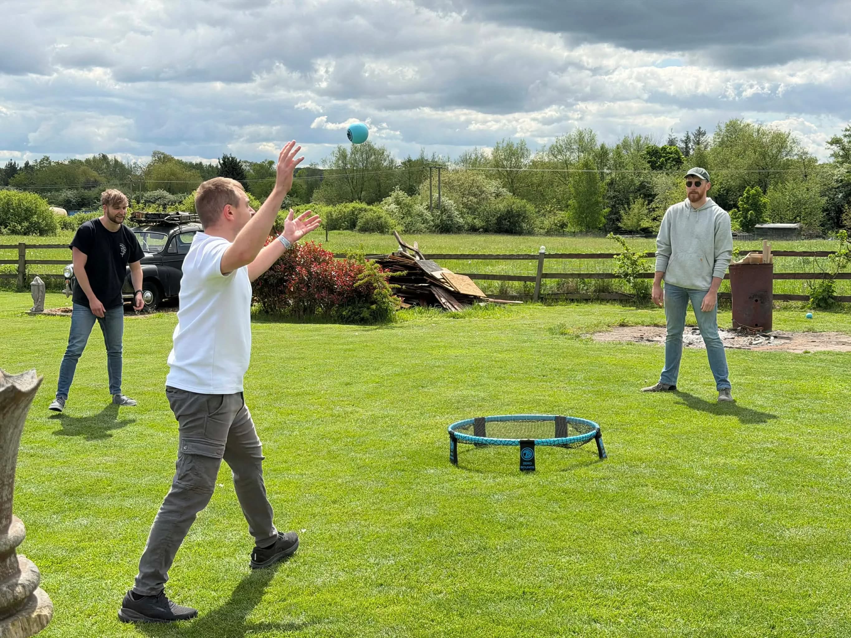 Roundnet being played in a garden